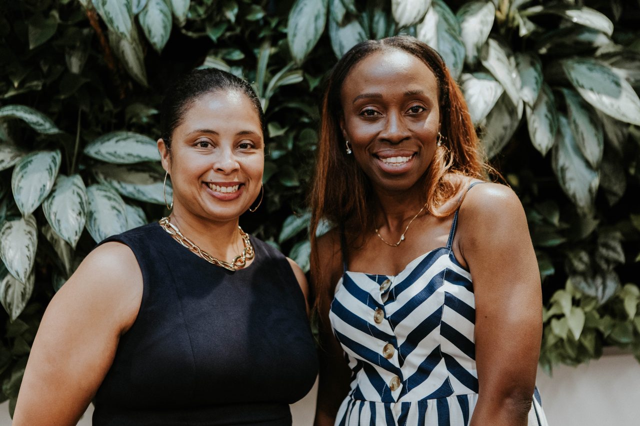 Two guests smiling together at an Open Access reception